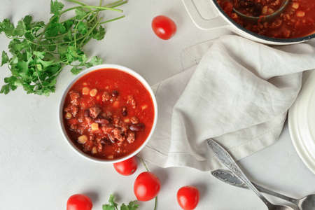 Bowl with delicious chili con carne on light backgroundの写真素材