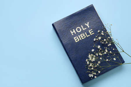 Holy Bible and flowers on color backgroundの写真素材