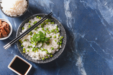 Plate with tasty rice and green peas on color backgroundの写真素材