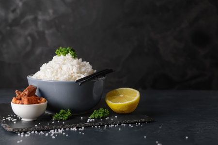 Bowl with tasty rice and meat on dark backgroundの写真素材