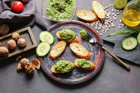 Composition with tasty pesto sauce and toasts on dark backgroundの写真素材