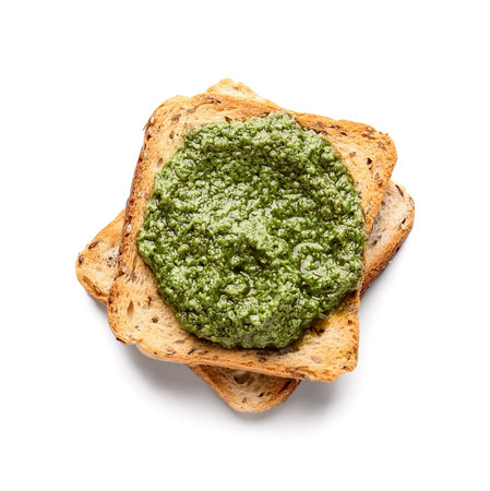 Tasty toast with pesto sauce on white backgroundの写真素材