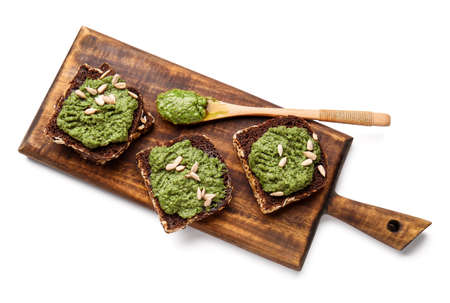 Tasty toasts with pesto sauce on white backgroundの写真素材
