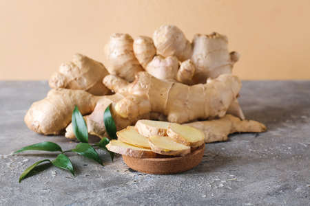 Composition with fresh ginger on tableの写真素材