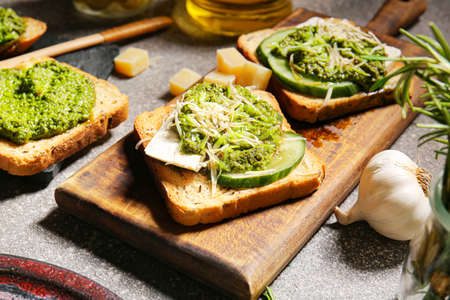 Tasty toasts with pesto sauce on grunge background, closeupの写真素材