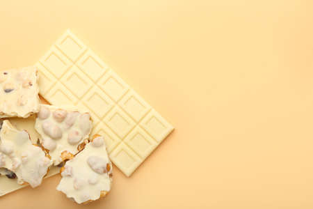 Tasty white chocolate on color background