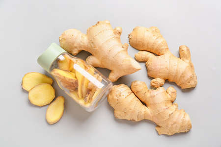Composition with fresh ginger on gray background