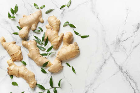 Composition with fresh ginger on light background