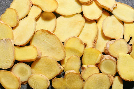 Many fresh ginger slices as background, closeup