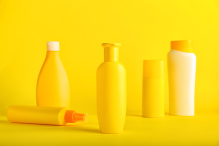 Bottles of cosmetic products on color backgroundの写真素材