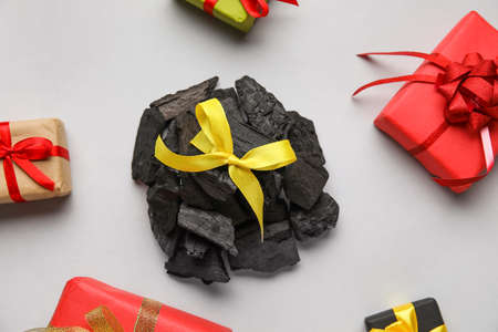 Coal with ribbon and gift boxes on light backgroundの写真素材
