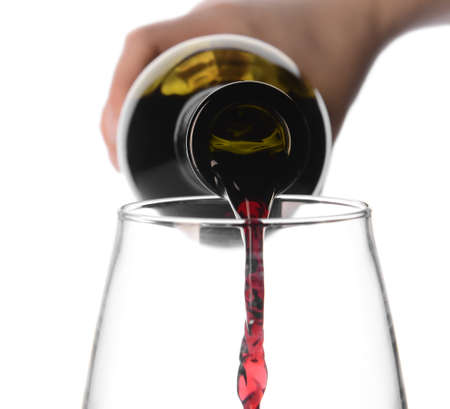Woman pouring exquisite wine in glass on white background, closeup