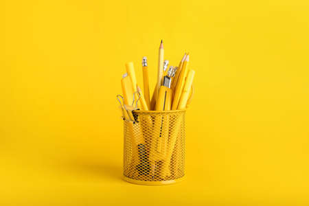 Holder with different stationery on color background