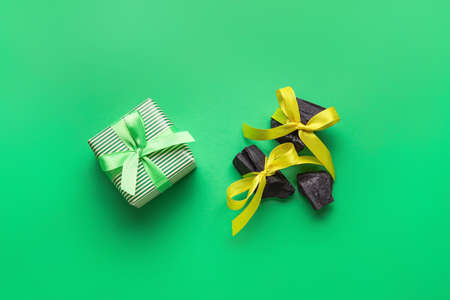 Coal with Christmas gift on color backgroundの写真素材