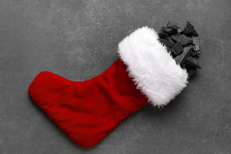 Christmas sock with coal on dark backgroundの写真素材