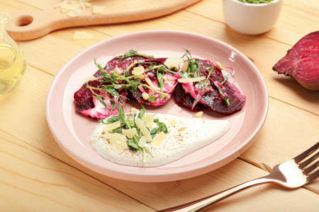 Plate with delicious beetroot carpaccio on wooden backgroundの写真素材