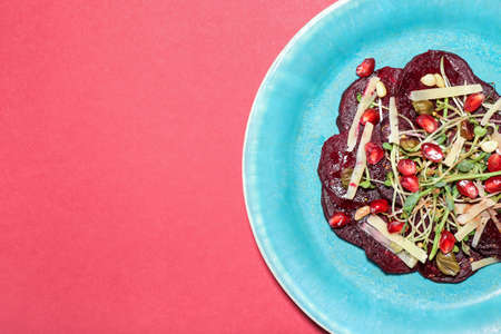 Plate with delicious beetroot carpaccio on color background