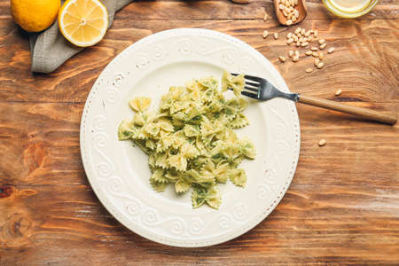 Plate with tasty pesto pasta on tableの写真素材