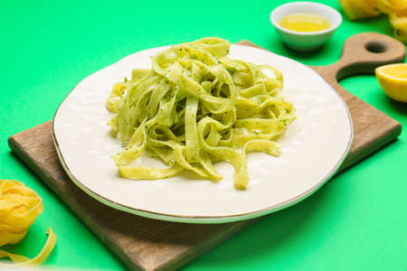 Plate with tasty pesto pasta on color backgroundの写真素材