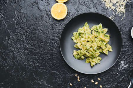 Plate with tasty pesto pasta on dark backgroundの写真素材