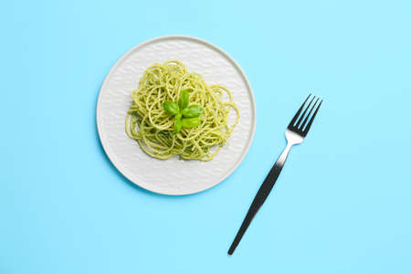 Plate with tasty pesto pasta on color backgroundの写真素材