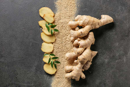 Fresh and ground ginger on dark background