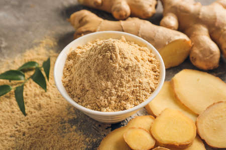Bowl with ginger powder on grunge background, closeupの写真素材
