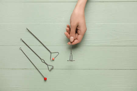 Woman with logopedic tools for speech correction on color wooden background
