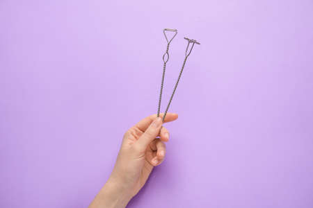 Female hand and logopedic tools for speech correction on color backgroundの写真素材