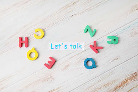 Paper with text LET'S TALK and letters on white wooden backgroundの写真素材