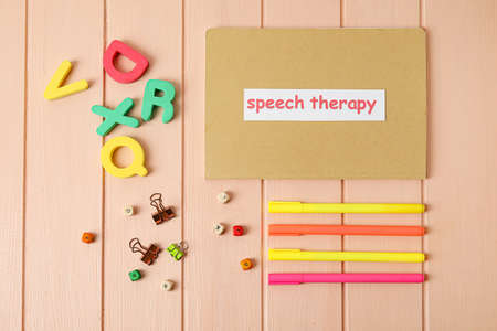 Composition with text SPEECH THERAPY and letters on color wooden backgroundの写真素材