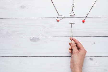 Female hand and logopedic tools for speech correction on white wooden backgroundの写真素材