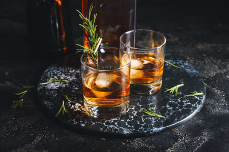 Glasses of cold whiskey on dark backgroundの写真素材