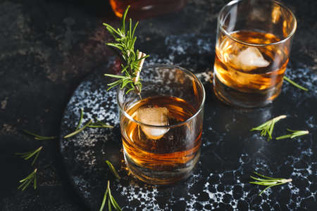 Glasses of cold whiskey on dark backgroundの写真素材