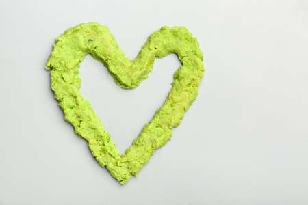 Heart made of tasty guacamole on light backgroundの写真素材