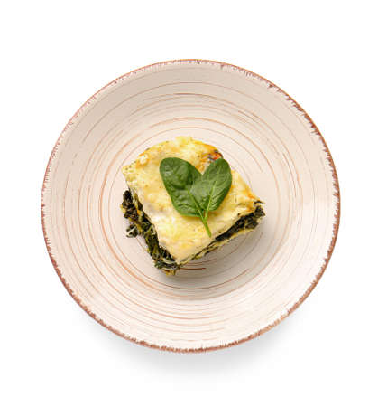 Plate with piece of tasty green lasagna on white backgroundの写真素材