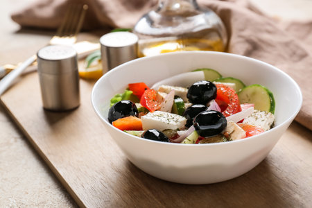Bowl with tasty Greek salad on tableの写真素材