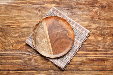 Fabric napkin and plate on wooden backgroundの写真素材
