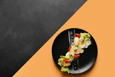 Plate with delicious Caesar salad on color backgroundの写真素材