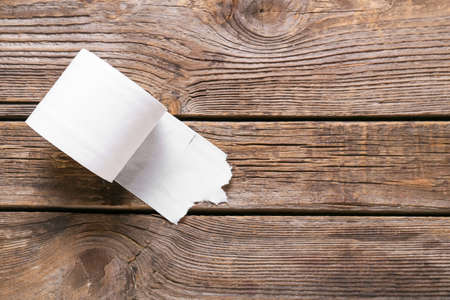 Roll of toilet paper on wooden backgroundの写真素材