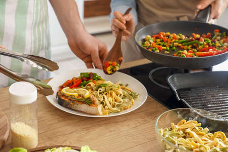 young couple cooking in the kitchenの写真素材