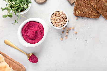 Composition with tasty beet hummus and ingredients on light backgroundの写真素材
