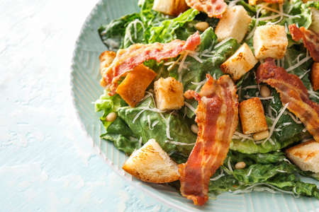 Plate with tasty Caesar salad on light background, closeupの写真素材