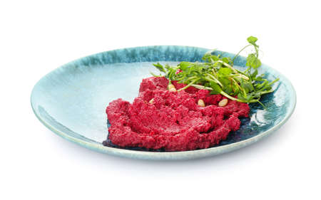 Plate with tasty beet hummus and fresh sprouts on white backgroundの写真素材