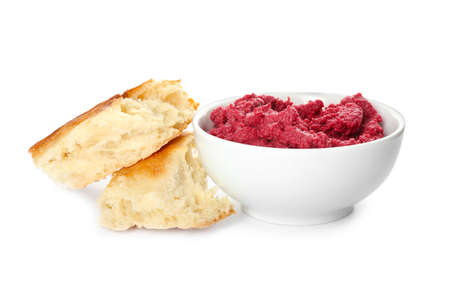 Bowl with tasty beet hummus and pita bread on white background