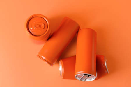 Cans of soda on color background