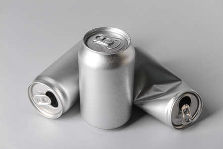 Cans of soda on gray background