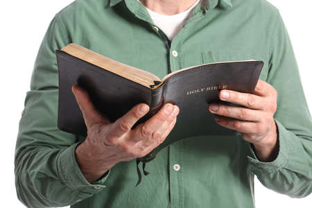 Man with Bible on white background, closeup