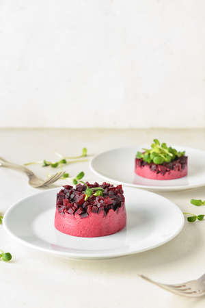 Plates with tasty tartare salad on light backgroundの写真素材