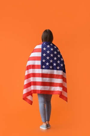 Young woman with USA flag on color background. memorial day celebrationの写真素材